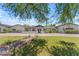 Stunning single-story home with lush lawn, manicured landscaping, and charming front entry at 8213 E Sharon Dr, Scottsdale, AZ 85260
