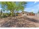 House exterior featuring desert landscaping with lush trees, plants, and gravel ground cover at 8213 E Sharon Dr, Scottsdale, AZ 85260