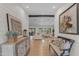 Bright hallway leading to a spacious living room, adorned with decorative art and stylish furnishings at 8213 E Sharon Dr, Scottsdale, AZ 85260