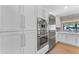 Bright kitchen features stainless steel appliances, ample cabinet space, and a large window overlooking the yard at 8213 E Sharon Dr, Scottsdale, AZ 85260