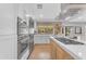 Modern kitchen with stainless steel appliances, white cabinets, and sleek countertops at 8213 E Sharon Dr, Scottsdale, AZ 85260