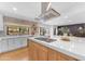 Kitchen with center island, stainless steel appliances, open cabinets, and view into dining and Gathering rooms at 8213 E Sharon Dr, Scottsdale, AZ 85260