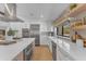 Modern kitchen featuring stainless steel appliances, sleek countertops, ample cabinet space, and a bright window at 8213 E Sharon Dr, Scottsdale, AZ 85260