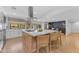Gourmet kitchen with a large center island, barstool seating, stainless steel appliances, and bright natural light at 8213 E Sharon Dr, Scottsdale, AZ 85260