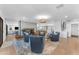 Open-concept living area featuring hardwood floors, accent fireplace, and seamless flow to the kitchen at 8213 E Sharon Dr, Scottsdale, AZ 85260