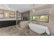 A luxurious main bathroom with a freestanding tub, walk-in shower, and modern fixtures at 8213 E Sharon Dr, Scottsdale, AZ 85260