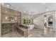 A main bathroom boasts a glass shower, soaking tub, unique pendant lighting, and hexagon tile flooring at 8213 E Sharon Dr, Scottsdale, AZ 85260