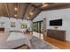 Spacious main bedroom featuring vaulted beamed ceilings, hardwood floors and glass sliding door at 8213 E Sharon Dr, Scottsdale, AZ 85260