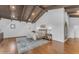 A well-lit main bedroom with exposed wood beam ceiling, hardwood floors and tasteful decor at 8213 E Sharon Dr, Scottsdale, AZ 85260