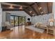 Luxurious main bedroom with vaulted beamed ceilings, glass sliding door and hardwood floors at 8213 E Sharon Dr, Scottsdale, AZ 85260