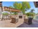 Comfortable outdoor seating area featuring a fireplace and a grill, perfect for entertaining at 8213 E Sharon Dr, Scottsdale, AZ 85260