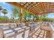 Outdoor kitchen featuring built-in stainless steel grill, shaded by a stylish pergola at 8213 E Sharon Dr, Scottsdale, AZ 85260