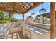 Outdoor kitchen area equipped with stainless steel grill, sink, and plenty of counter space at 8213 E Sharon Dr, Scottsdale, AZ 85260