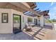 Inviting outdoor patio featuring comfortable seating and a stylish pergola with string lights at 8213 E Sharon Dr, Scottsdale, AZ 85260