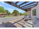 Relaxing patio area with stylish furniture and a pergola, perfect for outdoor entertaining with lush landscaping view at 8213 E Sharon Dr, Scottsdale, AZ 85260