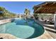 Sparkling swimming pool with a covered seating area and lounge chairs, perfect for summer days at 8213 E Sharon Dr, Scottsdale, AZ 85260