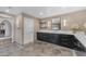 A main bathroom vanity area is complete with sleek dark cabinetry and modern fixtures at 8213 E Sharon Dr, Scottsdale, AZ 85260