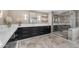 Bathroom vanity features sleek dark cabinets, stone countertops, and modern fixtures at 8213 E Sharon Dr, Scottsdale, AZ 85260