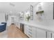 Modern wet bar features white cabinets, wine refrigerator, and decorative open shelving at 8213 E Sharon Dr, Scottsdale, AZ 85260