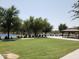 Green community space with a grassy lawn, a gazebo, and pickleball courts providing recreational opportunities at 8422 W Mantle Way, Florence, AZ 85132