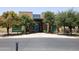 Community center entrance framed by mature trees and featuring a brick facade and glass entryway at 8422 W Mantle Way, Florence, AZ 85132