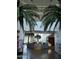 Spacious community center lobby featuring soaring ceilings, lush palm trees, and a modern reception area at 8422 W Mantle Way, Florence, AZ 85132