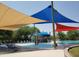 Fun splash pad with colorful shades, lounge chairs, and water features for to enjoy a hot day at 8422 W Mantle Way, Florence, AZ 85132