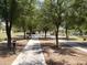 Shaded walkway lined with mature trees, offering a peaceful and scenic path for residents to enjoy at 8422 W Mantle Way, Florence, AZ 85132