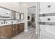 Tastefully designed main bathroom features double vanity, wood cabinets, and glass-enclosed shower at 8848 E Conquistadores Dr, Scottsdale, AZ 85255