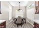 Cozy dining area with modern light fixture and big windows provides lots of natural light at 8848 E Conquistadores Dr, Scottsdale, AZ 85255