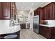 Modern kitchen features stainless steel appliances, dark wood cabinets, and stone countertops at 8848 E Conquistadores Dr, Scottsdale, AZ 85255