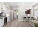 Connected kitchen and living spaces with hardwood floors, modern fixtures and breakfast bar at 8848 E Conquistadores Dr, Scottsdale, AZ 85255