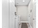 Bright laundry room with new washer and dryer, cabinet and door to the house at 8848 E Conquistadores Dr, Scottsdale, AZ 85255
