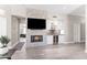 Spacious living room features a stone fireplace, modern wet bar, and hardwood style flooring at 8848 E Conquistadores Dr, Scottsdale, AZ 85255