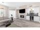 Inviting living room features a stone fireplace, sleek wet bar, and hardwood-style floors at 8848 E Conquistadores Dr, Scottsdale, AZ 85255