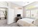 Bright main bedroom with large windows, ceiling fan, and open entry to the bathroom at 8848 E Conquistadores Dr, Scottsdale, AZ 85255