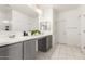 Bright bathroom with double sinks, gray cabinets, white countertops, and tiled floors at 10625 S 55Th Dr, Laveen, AZ 85339