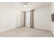 Bedroom has neutral carpet and light walls, with natural light and simple decor at 10625 S 55Th Dr, Laveen, AZ 85339