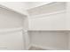 Walk-in closet features shelves and rods to organize clothing, shoes and accessories at 10625 S 55Th Dr, Laveen, AZ 85339