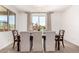 Elegant dining room features a stylish dark wood table with six upholstered chairs and natural light at 10625 S 55Th Dr, Laveen, AZ 85339