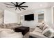 Bright living room features neutral color palette, large windows, ceiling fan, and wood-look tile flooring at 10625 S 55Th Dr, Laveen, AZ 85339