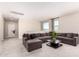 Bright living room with a large sectional sofa, neutral walls, and ample natural light from the windows at 10625 S 55Th Dr, Laveen, AZ 85339