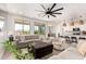 Inviting open-concept living room with modern pendant lights, and easy access to the kitchen and backyard at 10625 S 55Th Dr, Laveen, AZ 85339