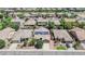 Aerial view of a neighborhood showcasing tiled roofs, mature landscaping, and solar panels at 11318 W Monte Vista Rd, Avondale, AZ 85392