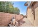 Backyard features a rock area, a brick fence, and a pool water filtration system at 11318 W Monte Vista Rd, Avondale, AZ 85392