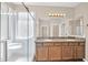 A bathroom with double sinks, granite countertops, and a glass-enclosed shower at 11318 W Monte Vista Rd, Avondale, AZ 85392