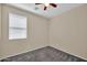 Cozy bedroom with carpet flooring, neutral walls, and a bright window at 11318 W Monte Vista Rd, Avondale, AZ 85392