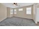 Spacious bedroom with neutral tones, ceiling fan, and three bright windows at 11318 W Monte Vista Rd, Avondale, AZ 85392