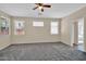 A bedroom with neutral paint, multiple windows, and plush carpeting at 11318 W Monte Vista Rd, Avondale, AZ 85392