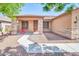 Inviting front porch with stone pillars, walkway, and desert landscaping for great curb appeal at 11318 W Monte Vista Rd, Avondale, AZ 85392